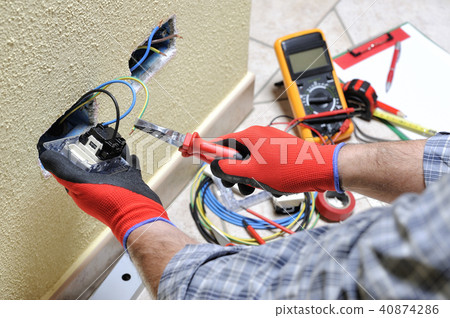 Electrician at work with safety equipment Electrician at work with safety equipment 40874286