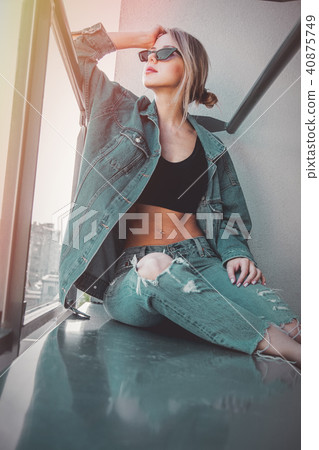 girl in jeans clothes and sunglasses on balcony girl in jeans clothes and sunglasses on balcony 40875749