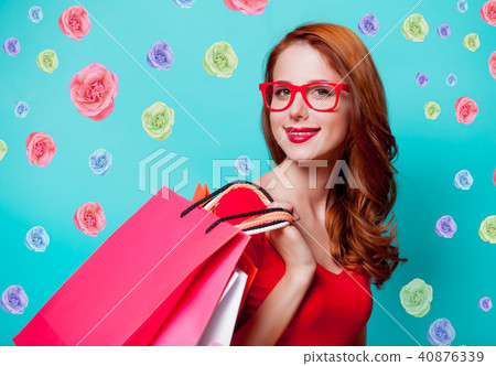 redhead girl in eyeglasses with shopping bags 40876339
