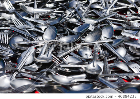 Pile of various stainless spoons and forks 40884235