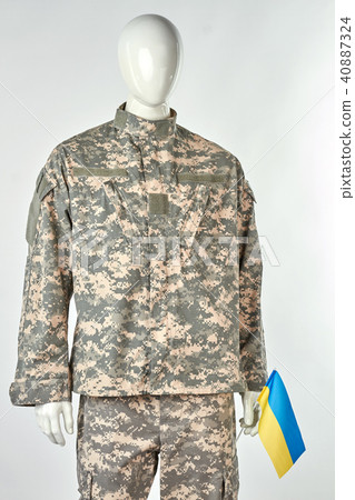 Mannequin in soldier uniform is holding ukrainian flag. Mannequin in soldier uniform is holding ukrainian flag. 40887324