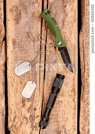Jackknife, dog tags and flashlight, top view. 40888308