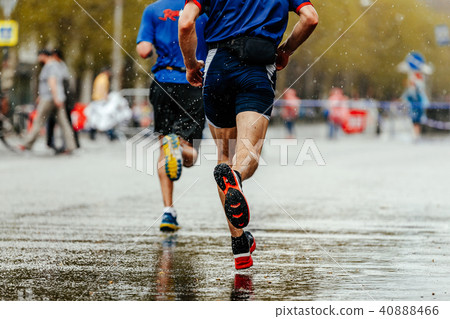 back two runners running under rain 40888466