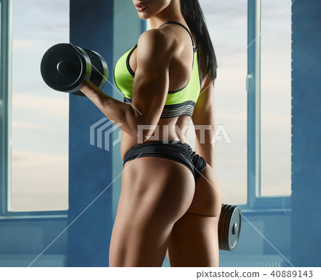 Cropped photo of strong fit model training in gym with heavy dumbbells. 40889143