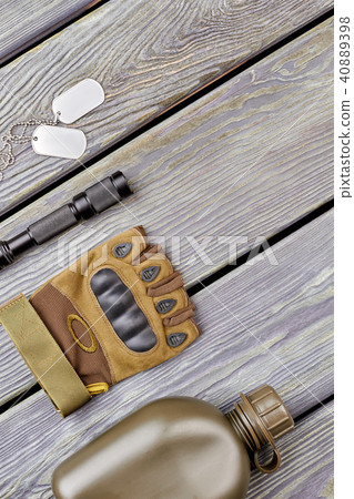 Military bottle, glove, flashlight, and dog tags. 40889398