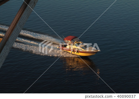 A fast motor boat is racing along the waves. 40890037