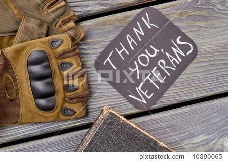 Pair of military veteran's gloves and old book. Pair of military veteran's gloves and old book. 40890065