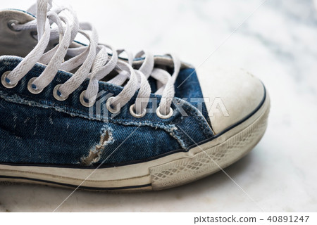 Old worn out blue sneaker Old worn out blue sneaker 40891247