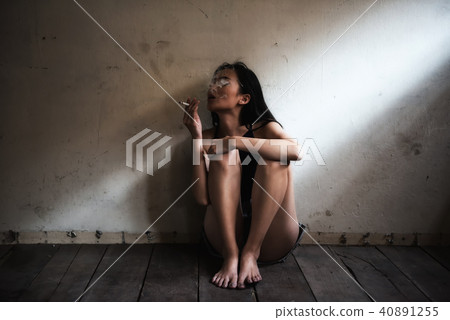 Depress Woman smoking in dark room Depress Woman smoking in dark room 40891255