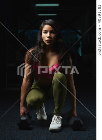 woman sitting with dumbbells 40891583