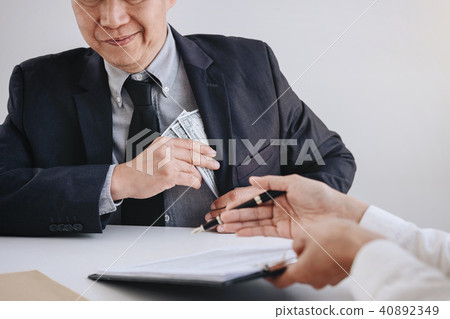 Bribery and corruption concept, bribe in the form of dollar bill Bribery and corruption concept, bribe in the form of dollar bill 40892349