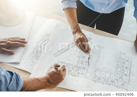 Hands of architect or engineer working on blueprint meeting for 40892406