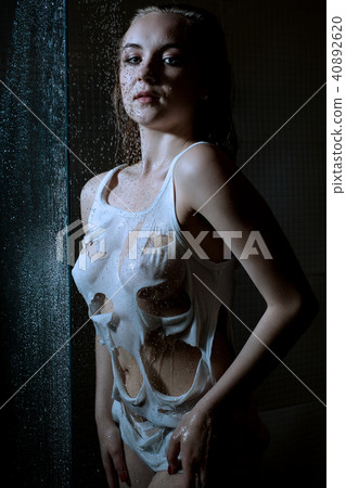 Sexy woman in a ragged top shower in the dark Sexy woman in a ragged top shower in the dark 40892620