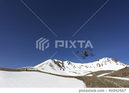 Quadrocopter hovered over the top against thesky. Quadrocopter hovered over the top against thesky. 40892667