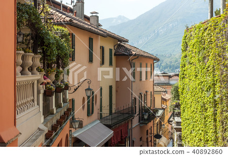 narrow street down to the lake Italy 40892860