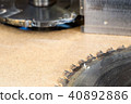 Carpenter tools on wooden table with sawdust. Circular Saw. Cutting a wooden plank 40892886