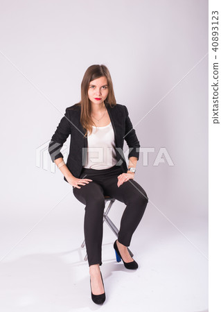 Caucasian attractive female model with brunette hair posing in studio, wearing formal suit isolated Caucasian attractive female model with brunette hair posing in studio, wearing formal suit isolated 40893123