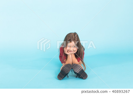 Sweet little girl over blue background with copyspace 40893267