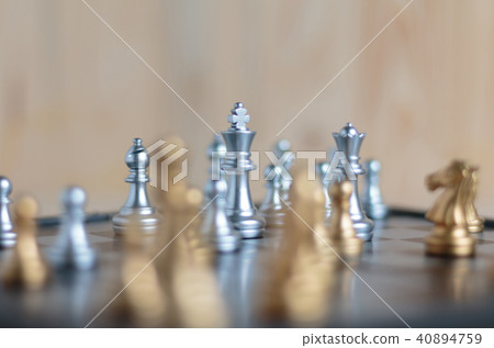 Silver and gold chess set on board Silver and gold chess set on board 40894759