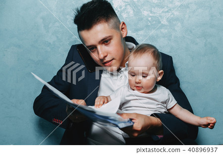 Father working at home office with daughter on lap 40896937