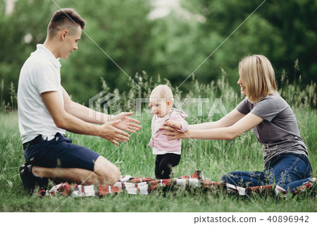 Baby girl doing first steps Baby girl doing first steps 40896942