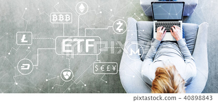 Cryptocurrency ETF theme with man using a laptop 40898843
