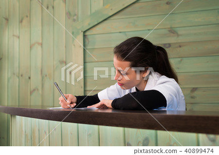 The female doctor sits at a table having closed eyes for fatigue 40899474