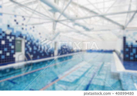 Modern indoor light swimming pool decorated with blue tiles. Blur background Modern indoor light swimming pool decorated with blue tiles. Blur background 40899480