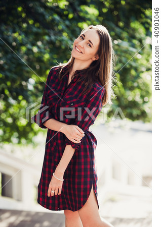 young pretty women with long windy hair in violet dress standing at stairs 40901046