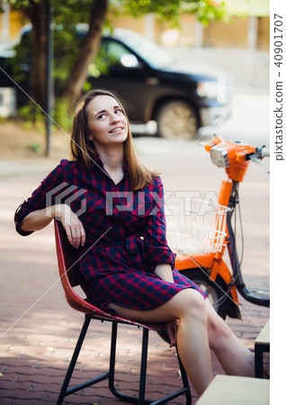 young attractive girl with beautiful smile wearing violet checkered dress and vintage old scooter young attractive girl with beautiful smile wearing violet checkered dress and vintage old scooter 40901707