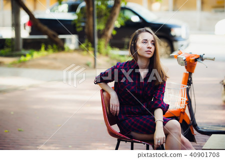 young attractive girl with beautiful smile wearing violet checkered dress and vintage old scooter young attractive girl with beautiful smile wearing violet checkered dress and vintage old scooter 40901708