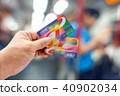 Hand holding an Octopus Smart card in MTR train  40902034