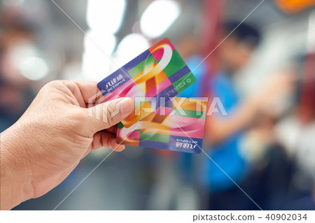 Hand holding an Octopus Smart card in MTR train  40902034