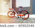 Modern two-wheeled bicycle indoors near color wall 40902046