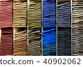 Wooden shelves with stack of different color socks 40902062