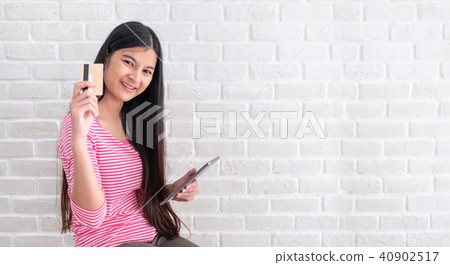 Asian woman in casual cloth holding credit card 40902517