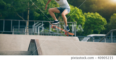 skateboarder skateboarding on skatepark ramp 40905215