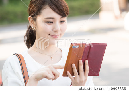 Business woman watching smaho Young Japanese lady 40908888