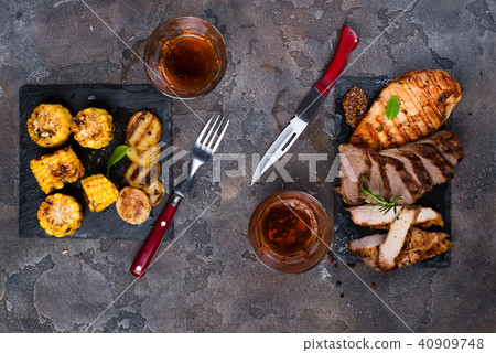 Fresh three types of grilled steak (chicken, pork, beef) on slate plate with herbs, tomato, juice Fresh three types of grilled steak (chicken, pork, beef) on slate plate with herbs, tomato, juice 40909748