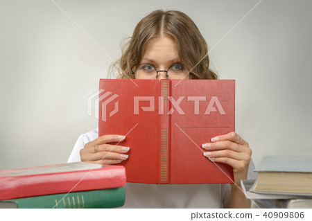 Girl in glasses with a red book Girl in glasses with a red book 40909806