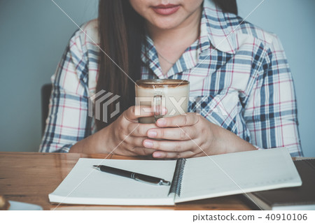 Woman hands holding hot cup of coffee Woman hands holding hot cup of coffee 40910106
