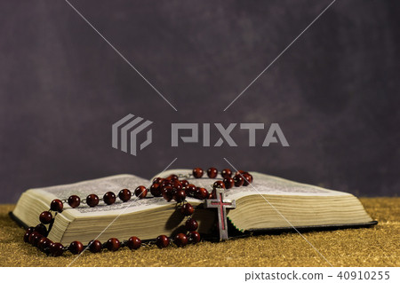 Bible and the crucifix on a gold table.  40910255
