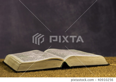 Bible and the crucifix on a gold table.  40910256