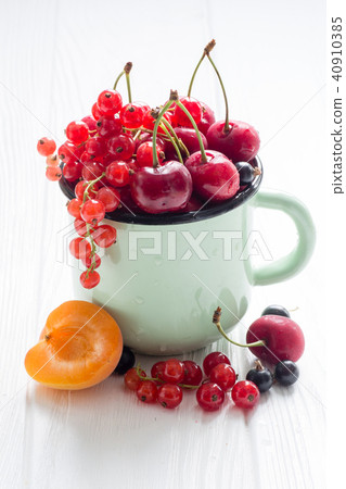 Different kinds of berries in enamel tea cup Different kinds of berries in enamel tea cup 40910385