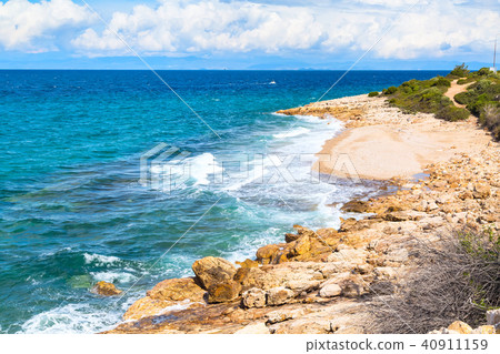Summer background with waves on stone beach shore Summer background with waves on stone beach shore 40911159