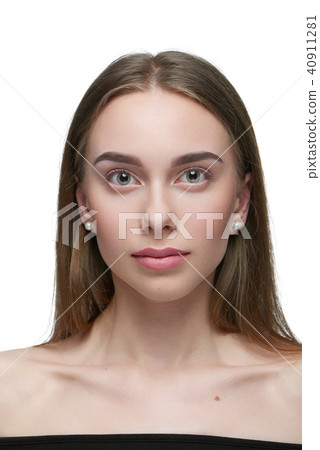 Portrait of a girl with light day make up looking at camera. 40911281