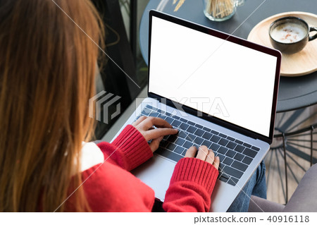 Woman sitting and using laptop computer. 40916118