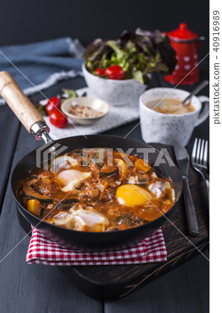Shakshuka, Fried Eggs in Tomato Sauce for Easter Brunch. Top view. Shakshuka, Fried Eggs in Tomato Sauce for Easter Brunch. Top view. 40916989