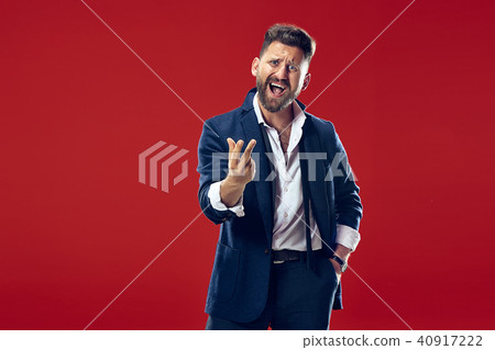 Beautiful male half-length portrait isolated on red studio backgroud. The young emotional surprised Beautiful male half-length portrait isolated on red studio backgroud. The young emotional surprised 40917222