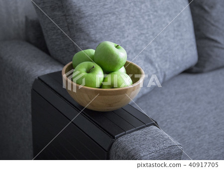 green fresh apples are in a wooden bowl in the kitchen green fresh apples are in a wooden bowl in the kitchen 40917705